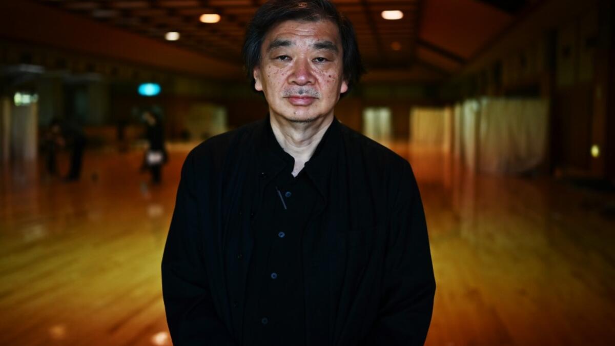 This photo taken on April 14, 2020 shows Japanese architect Shigeru Ban posing for a photo at the shelter he and his team devised which hosts people who can’t afford to rent an apartment and used to stay at designated internet cafes, now closed due to the COVID-19 coronavirus outbreak state of emergency, at a judo sport hall in Yokohama, Kanagawa prefecture.CHARLY TRIBALLEAU / AFP