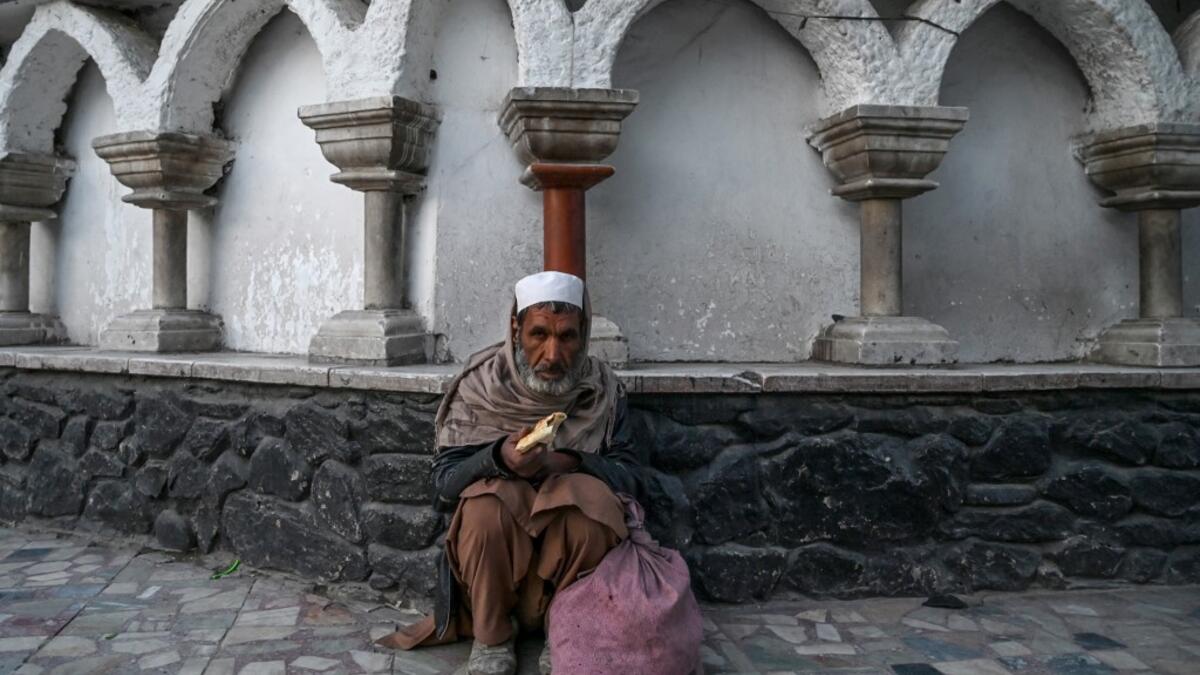 A Muslim man sits as he breaks his first fast day during the Muslim holy month of Ramadan outside a mosque in Kabul on April 24, 2020. The Taliban have dismissed a government call for a Ramadan ceasefire in Afghanistan, saying a truce is "not rational" as they ramp up attacks on government forces. WAKIL KOHSAR / AFP