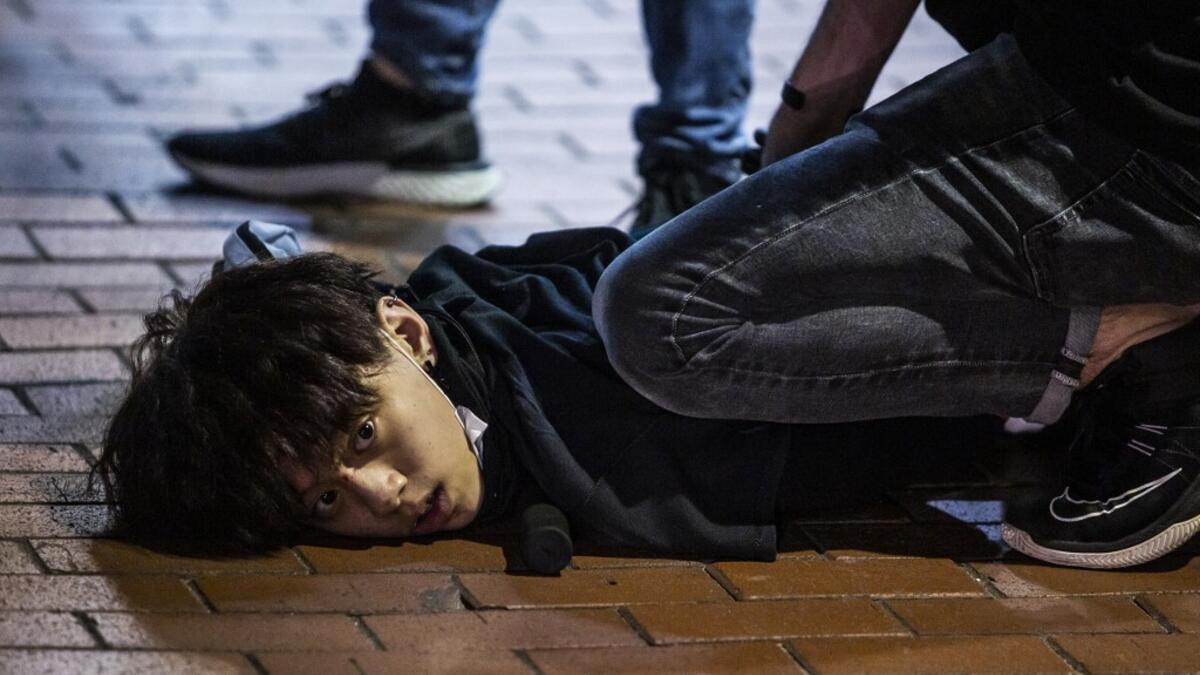 Undercover police arrest and handcuff a pro-democracy demonstrator (C) during a pro-democracy protest calling for the city's independence in Mong Kok district of Hong Kong on May 10, 2020. ISAAC LAWRENCE / AFP