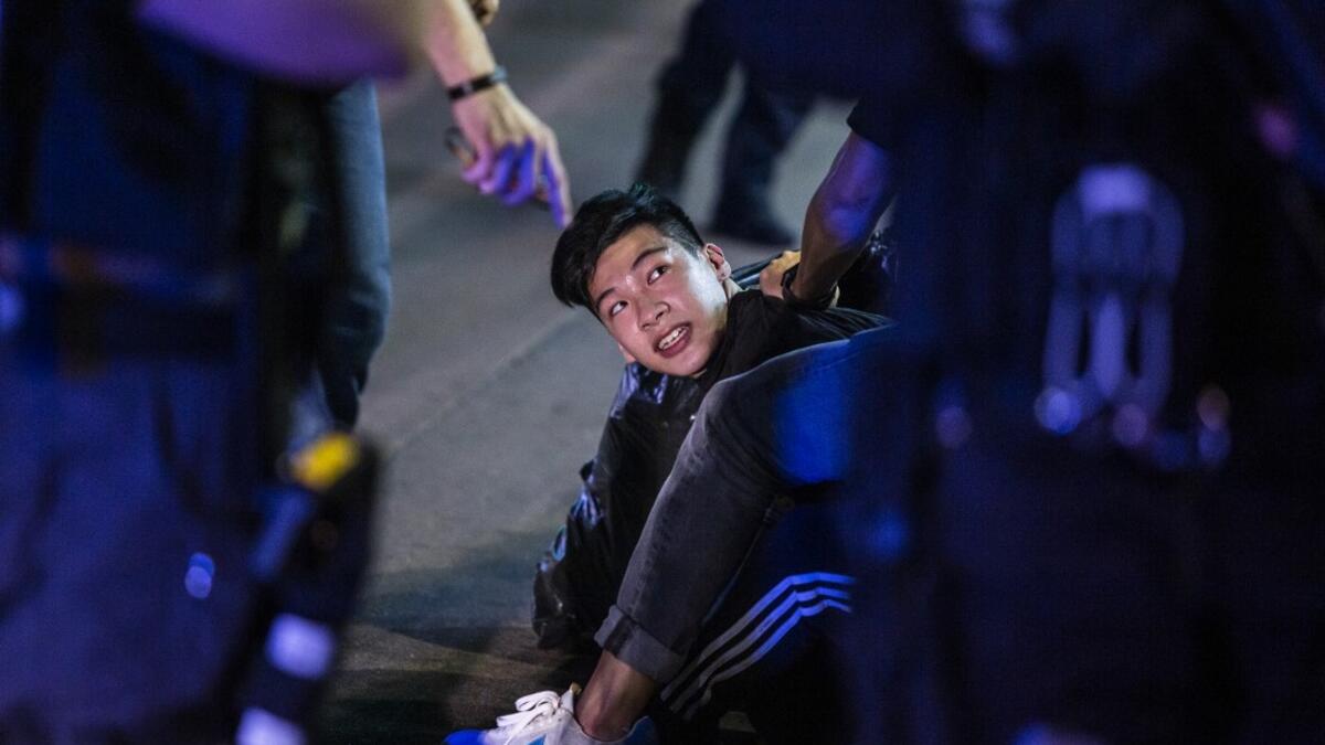 Undercover police arrest a pro-democracy demonstrator (C) during a pro-democracy protest calling for the city's independence in Mong Kok district of Hong Kong on May 10, 2020. ISAAC LAWRENCE / AFP