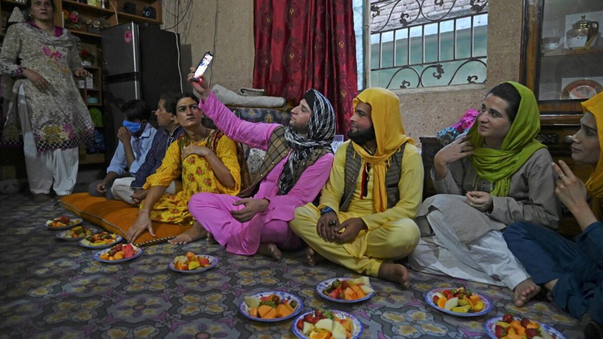 In this picture taken on May 9, 2020, members of the transgenders community gather to break their fast during the Islamic holy month of Ramadan at the Guru transgender house in Rawalpindi. Transgender people in the country are known as "khawajasiras" or "hijras" -- an umbrella term denoting a third sex that includes transgender women and cross-dressers. Pakistan became one of the first countries in the world to legally recognise a third sex in 2009 and began issuing transgender passports from 2017. Aamir QU