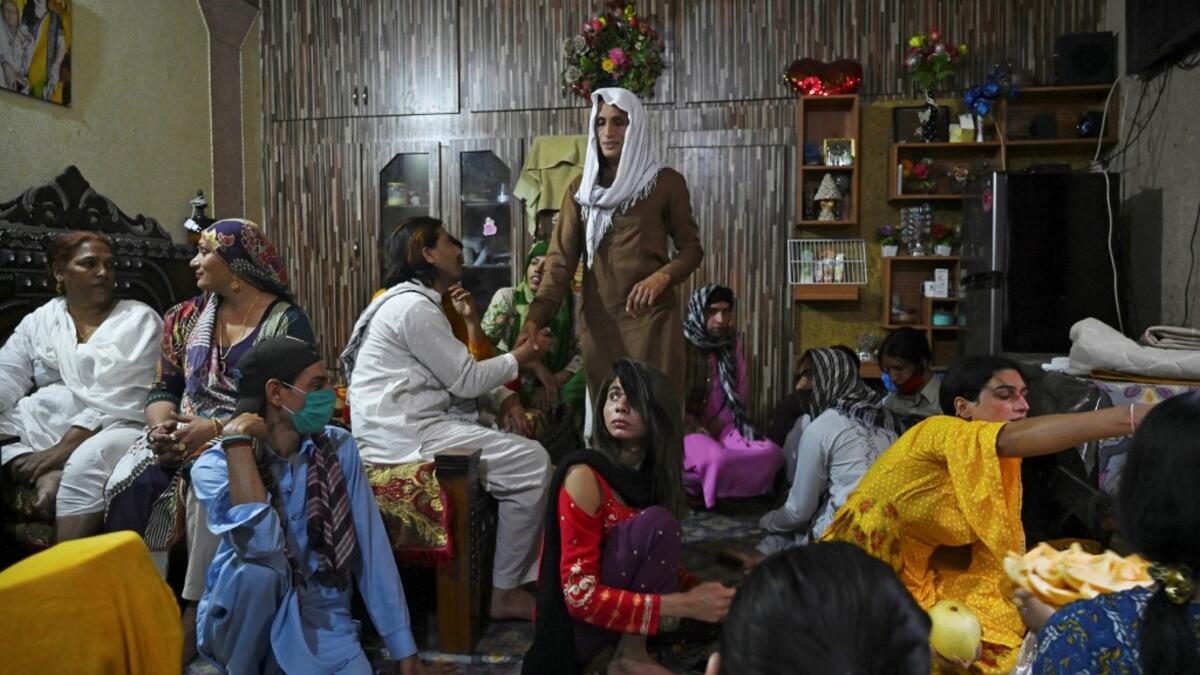 In this picture taken on May 9, 2020, members of the transgenders community gather to break their fast during the Islamic holy month of Ramadan at the Guru transgender house in Rawalpindi. Transgender people in the country are known as "khawajasiras" or "hijras" -- an umbrella term denoting a third sex that includes transgender women and cross-dressers. Pakistan became one of the first countries in the world to legally recognise a third sex in 2009 and began issuing transgender passports from 2017. Aamir QU