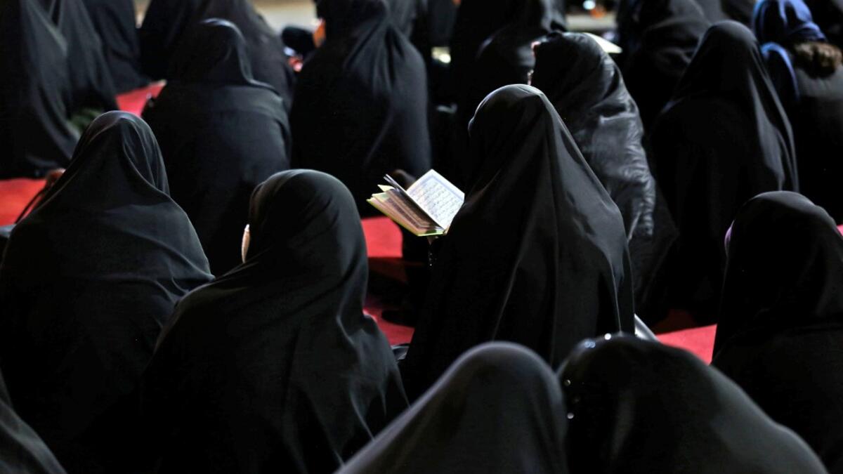 Iranian women attend Laylat al-Qadr prayers, one of the holiest nights during the Muslim fasting month of Ramadan, outside a mosque in the Tehran, on May 13, 2020. ATTA KENARE / AFP
