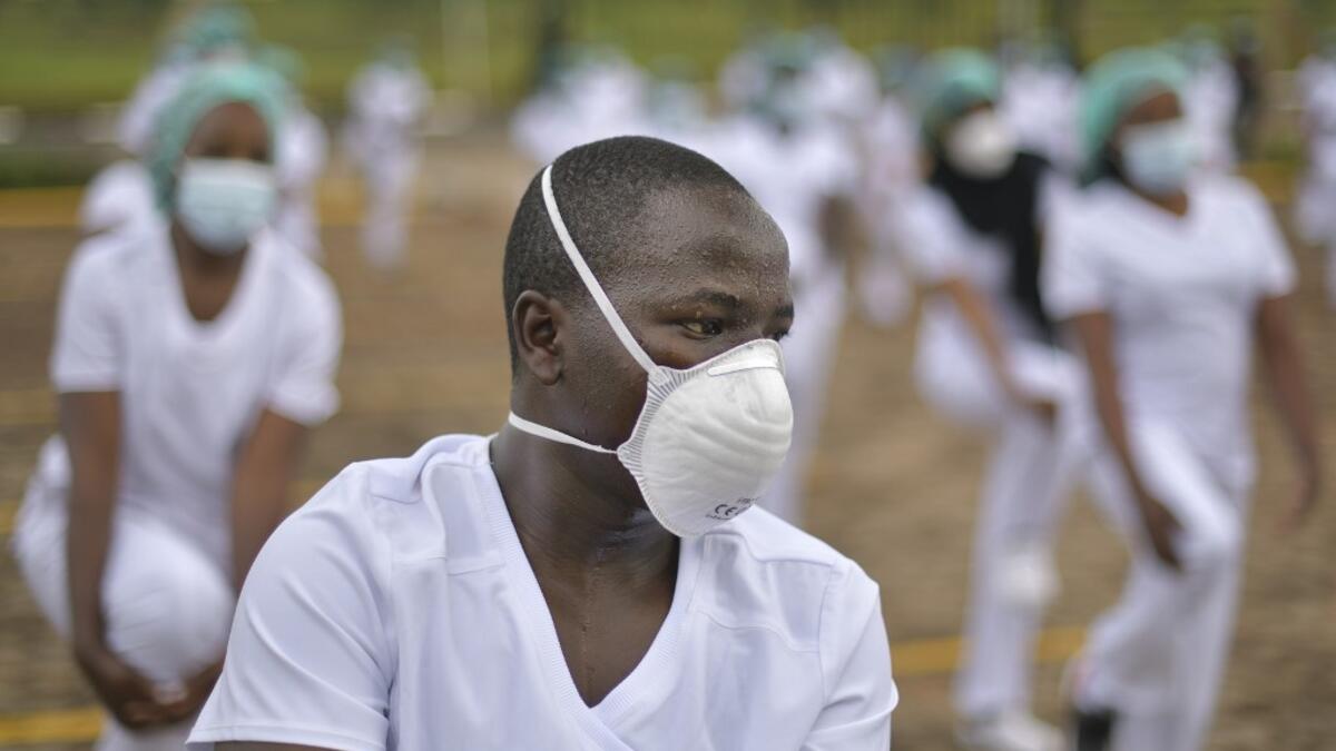 Nurses assigned to the Infectious Diseases Unit (IDU) at the Kenyatta University Hospital is seen dancing during a Zumba class held at the hospital compound in Nairobi, on May 17, 2020. Coinciding with the morning shift rotation the class, aimed to offer some respite to nurses charged with the management of patients infected with COVID-19 coronavirus, was organised by the Nursing Council of Kenya (NCK) and the Kenyatta Univesity Teaching, Refferal and Research Hospital in the Kenyan capital. TONY KARUMBA /