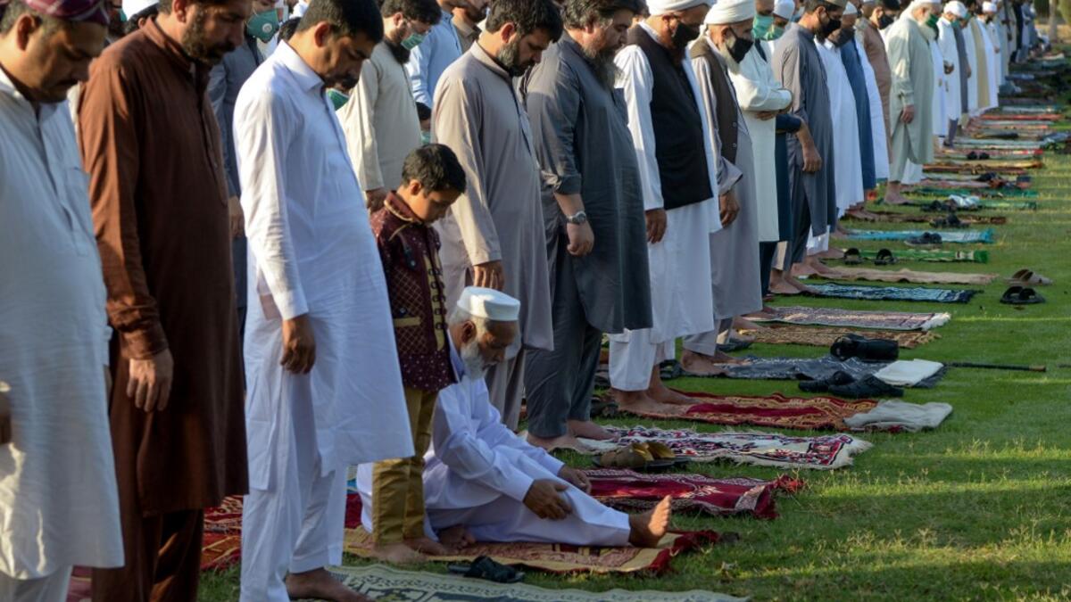 Muslims offer Eid al-Fitr prayers in Peshawar on May 24, 2020. Muslims around the world began marking a sombre Eid al-Fitr on May 24, many under coronavirus lockdown, but lax restrictions offer respite to worshippers in some countries despite fears of skyrocketing infections. Abdul MAJEED / AFP
