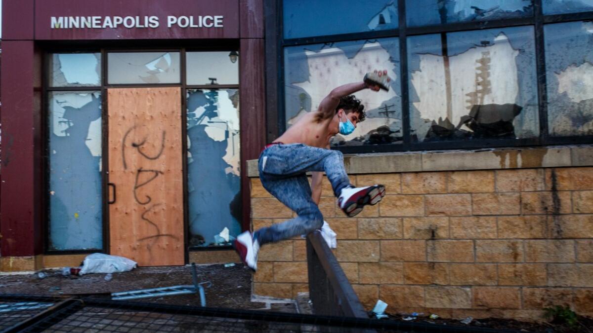Protesters try to break into the Third Police Precinct on May 28, 2020 in Minneapolis, Minnesota, during a protest over the death of George Floyd, an unarmed black man, who died after a police officer kneeled on his neck for several minutes. Authorities in Minneapolis and its sister city St. Paul got reinforcements from the National Guard on May 28 as they girded for fresh protests and violence over the shocking police killing of a handcuffed black man. (Kerem Yucel / AFP)