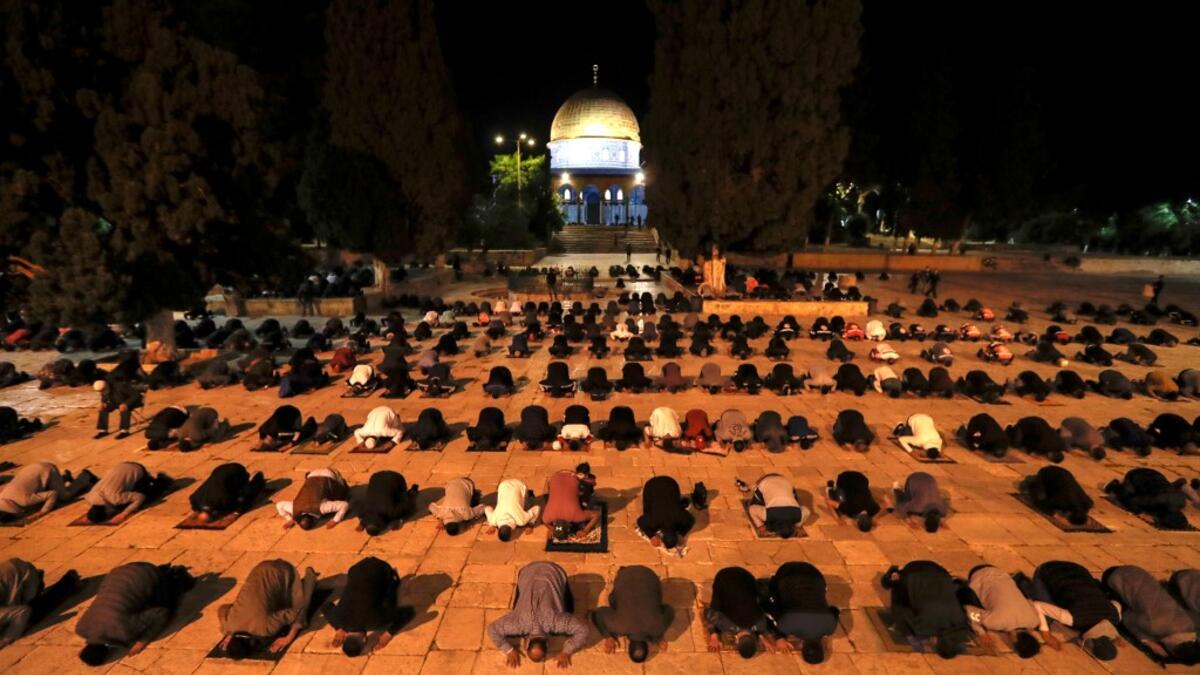 Palestinians perform the dawn prayer (salat al-fajr) inside the al-Aqsa mosque compound, in Jerusalem's Old City on May 31, 2020, after a two-month closure due to the COVID-19 pandemic. AHMAD GHARABLI / AFP