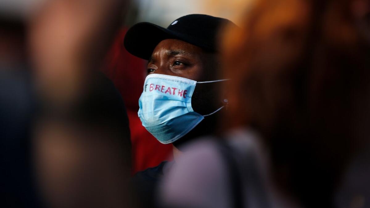 People take part in a protest over the police killing of George Floyd in the USA, on June 1, 2020 in Barcelona. The United States has erupted into days and nights of protests, violence, and looting, following the death of George Floyd after he was detained and held down by a knee to his neck, dying shortly after. Pau Barrena / AFP