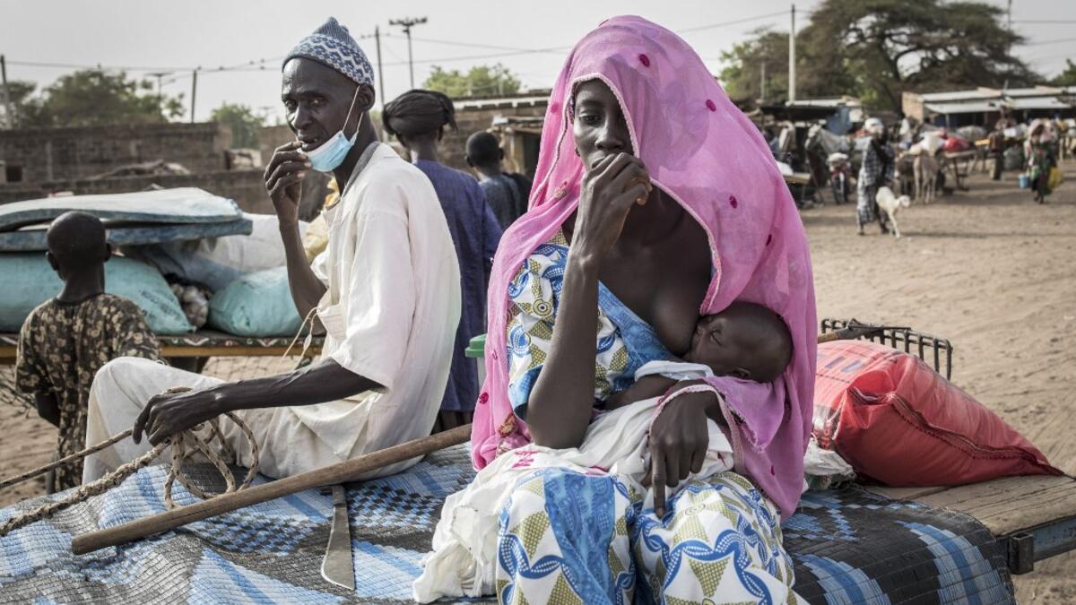 Fulani herders make their way back to their camps after trying to buy and sell goods at a unofficial herders market in Barkedji on May 28, 2020. COVID-19 coronavirus restrictions have closed down markets and regional movement, as a result Fulani herders are struggling to move to areas with more grazing land for there live stock. Closures of markets have meant that the prices for live stock has dropped by up to fifty percent, leaving the pastoralist stuck with out being able to pay for the provisions to move
