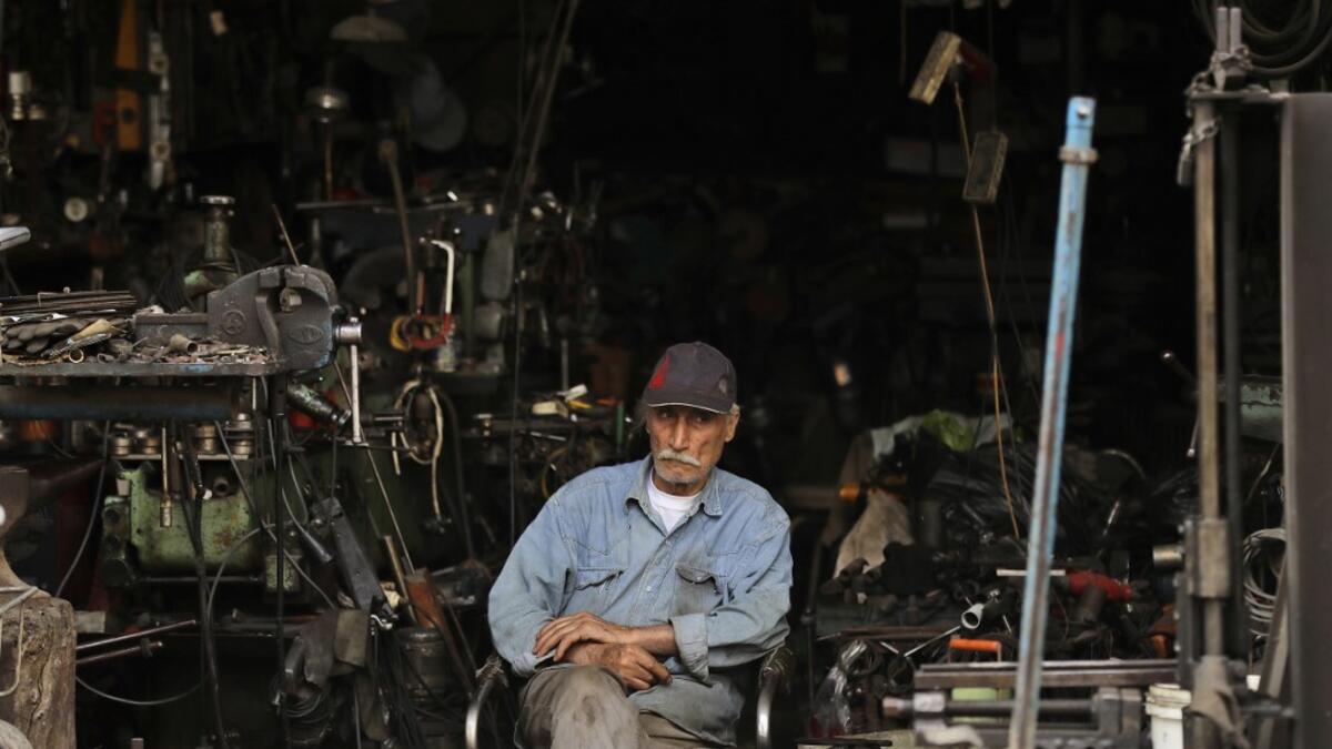 A man sits in a workshop in the Bab al-Tabbaneh neighbourhood of Lebanon's northern city of Tripoli on June 3, 2020. Thousands of residents of Lebanon's northern Tripoli struggle to put food on the table, as the country's worst economic crisis in decades has picked up in speed in recent weeks, with food prices rising by more than 70 percent since the autumn. Inflation has been a blow in the country where more than 45 percent of the country's population now lives below the poverty line, and more than 35 perc