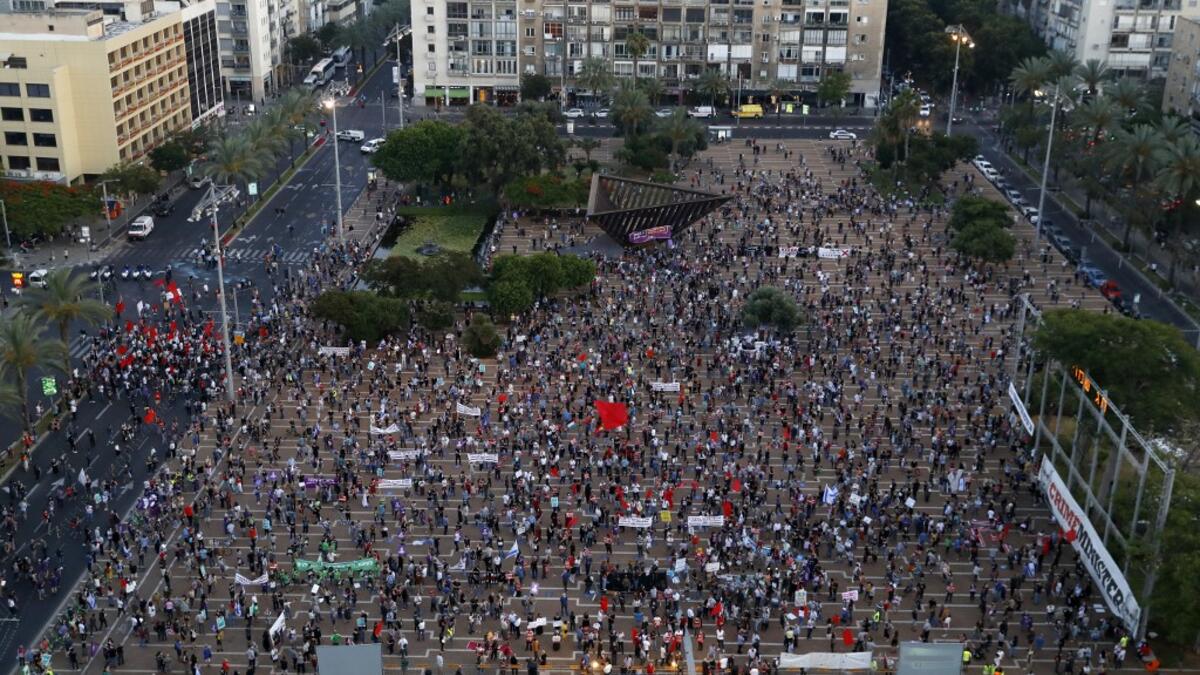 Protesters gather in Tel Aviv's Rabin Square on June 6, 2020, to denounce Israel's plan to annex parts of the occupied West Bank. Israeli Prime Minister Benjamin Netanyahu has vowed to forge ahead with annexing settlements and the Jordan Valley, in line with the peace proposals unveiled in January by US President Donald Trump. The plan has been angrily rejected by the Palestinians, who say they were not consulted on proposals they see as capitulating to Israeli demands. JACK GUEZ / AFP
