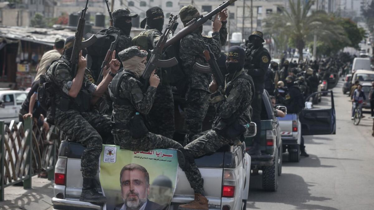 Members of the Palestinian Islamic Jihad group take part in a symbolic funeral for the movement's former leader Ramadan Shalah in Gaza city, on June 7, 2020, a day after he died in neighbouring Lebanon. The 62-year-old died in a Beirut hospital after a long illness, before his body was transported to neighbouring Syria, a Palestinian source said. MAHMUD HAMS / AFP
