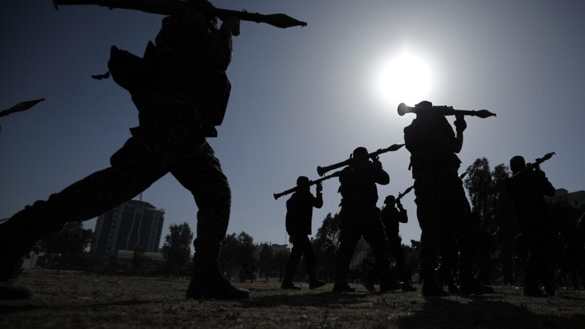 Members of the Palestinian Islamic Jihad group take part in a military parade during a condolences ceremony for the movement's former leader Ramadan Shalah in Gaza city, on June 8, 2020, two days after his death in neighbouring Lebanon. The 62-year-old was buried in Syria on June 7, a day following his death after a long illness. Mohammed ABED / AFP