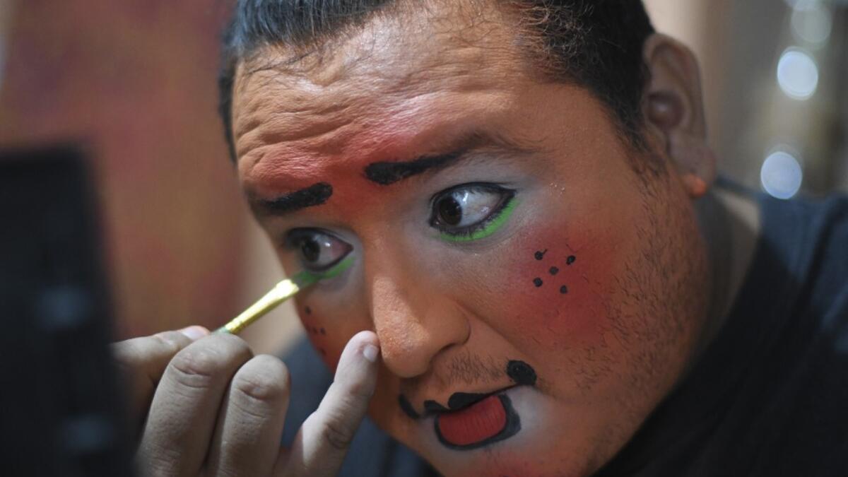 Chimbombita clown puts on make up before taking to the streets to beg for money to survive the crisis caused by the new coronavirus in Villa Nueva, 20 km south Guatemala City, on June 10, 2020, as clowns have been unable to work due to restrictions to prevent the spread of the COVID-19.Johan ORDONEZ / AFP
