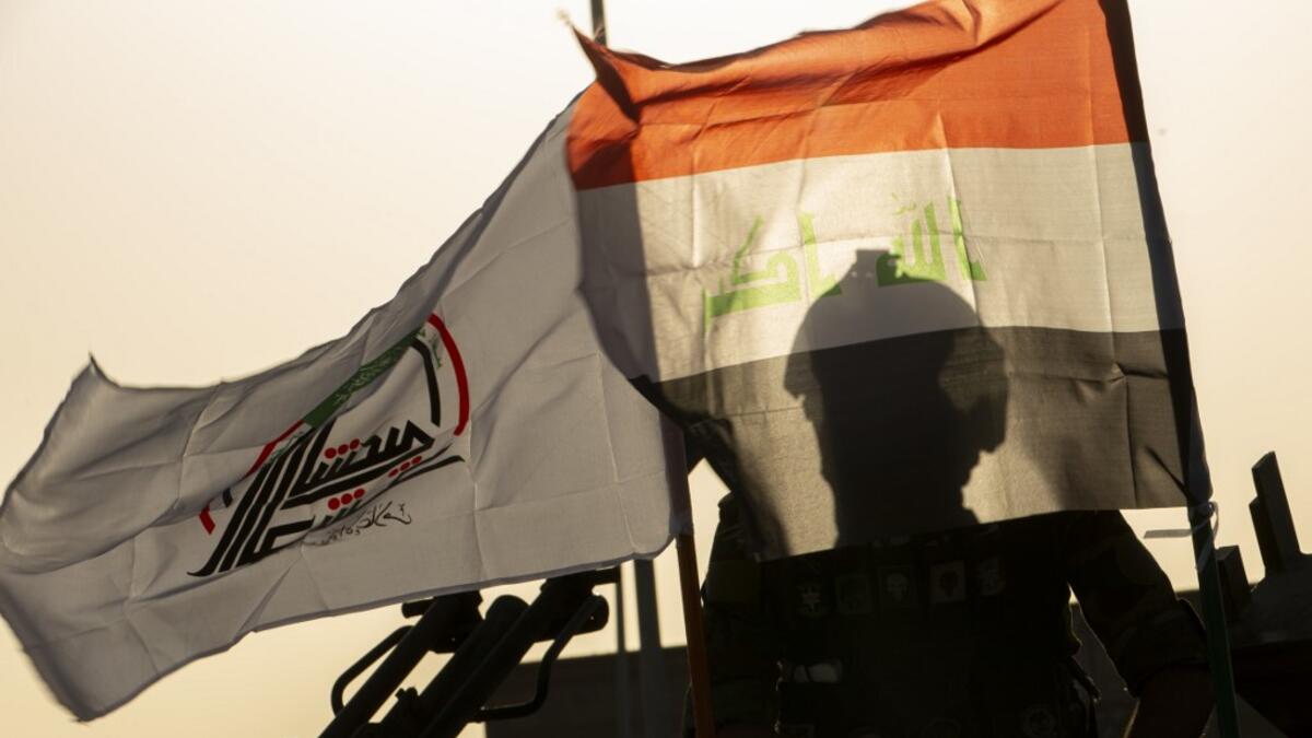 Members of the Hashed al-Shaabi (Popular Mobilisation) paramilitary force take part in a military parade in the southern Iraqi city of Basra on June 14, 2020, marking the sixth anniversary of its founding after Iraq's top Shiite cleric Grand Ayatollah Ali Sistani called to defend the country from the Islamic State group (IS). Hussein FALEH / AFP
