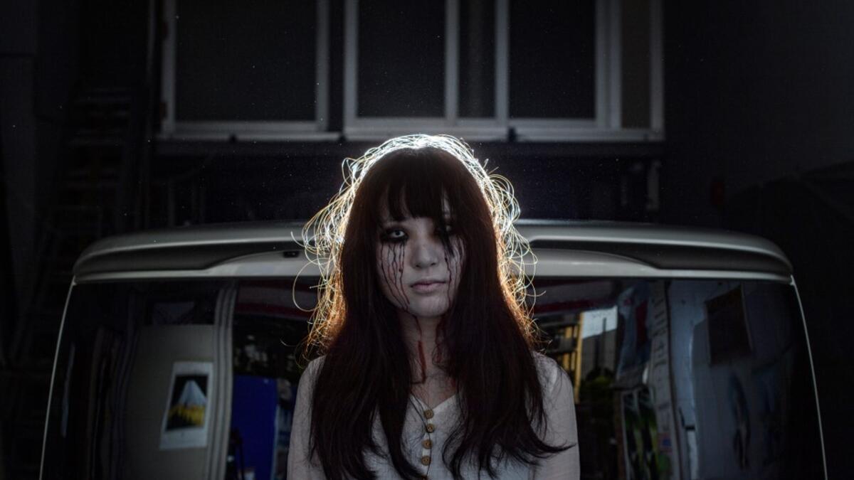 A car horn beeps and the horror begins: a bloody murder and rampaging zombies. But this drive-in haunted house in Japan protects against the most terrifying enemy of all -- coronavirus. Inside a car, guests can scream as loudly as they like, with no mask required, as hideous creatures daubed in blood swarm towards them.  Philip FONG / AFP