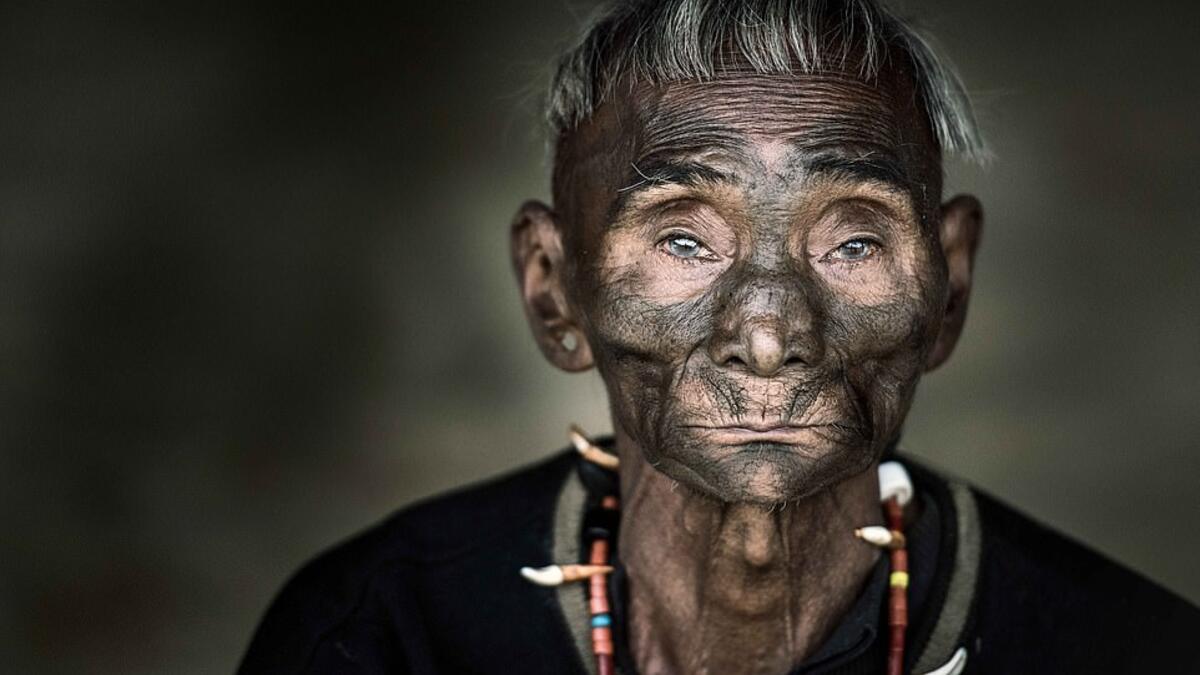 A tribesman wears an ornate necklace made of animal teeth and beads. (Mediadrumimages/ Trevor Cole)