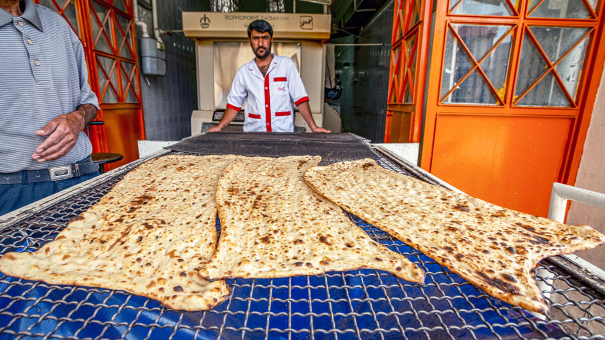 Fars Province Iran, bakers are baking Sangak bread in a traditional oven by traditional method, Sangak bread was traditionally the bread of the Persian army  (Shutterstock)