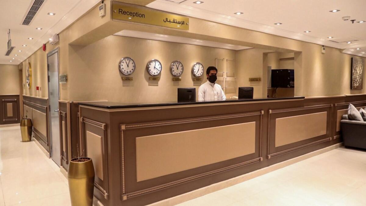 A reception staff wears a protective mask at a hotel in the holy city of Mecca on June 27, 2020. This year's hajj, which has been scaled back dramatically to include only around 1,000 Muslim pilgrims as Saudi Arabia battles a coronavirus surge, will begin on July 29, authorities said. AFP