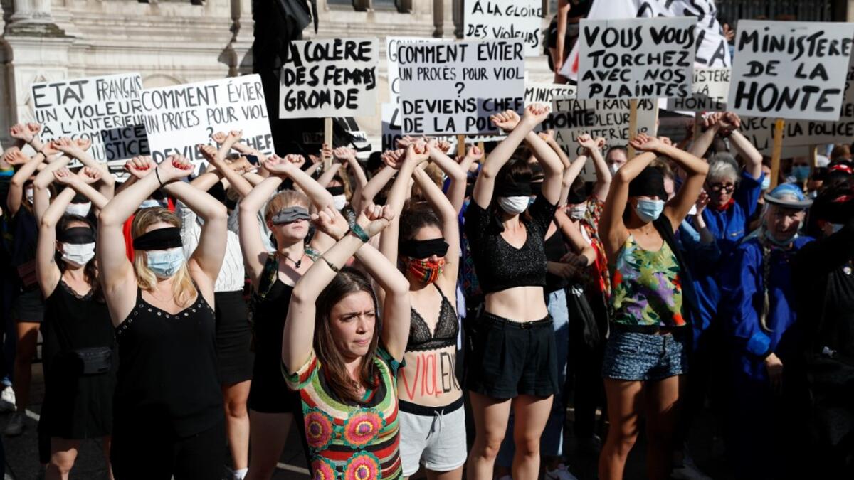Protesters perform a dance inspired by the Chilean feminist group "Las Tesis" during a demonstration called by feminist movements in front of the city hall in Paris, on July 10, 2020, to denounce the nomination of French Interior Minister, facing rape accusations and French Justice Minister who criticised the #MeToo movement against sexual harassment. Thomas COEX / AFP