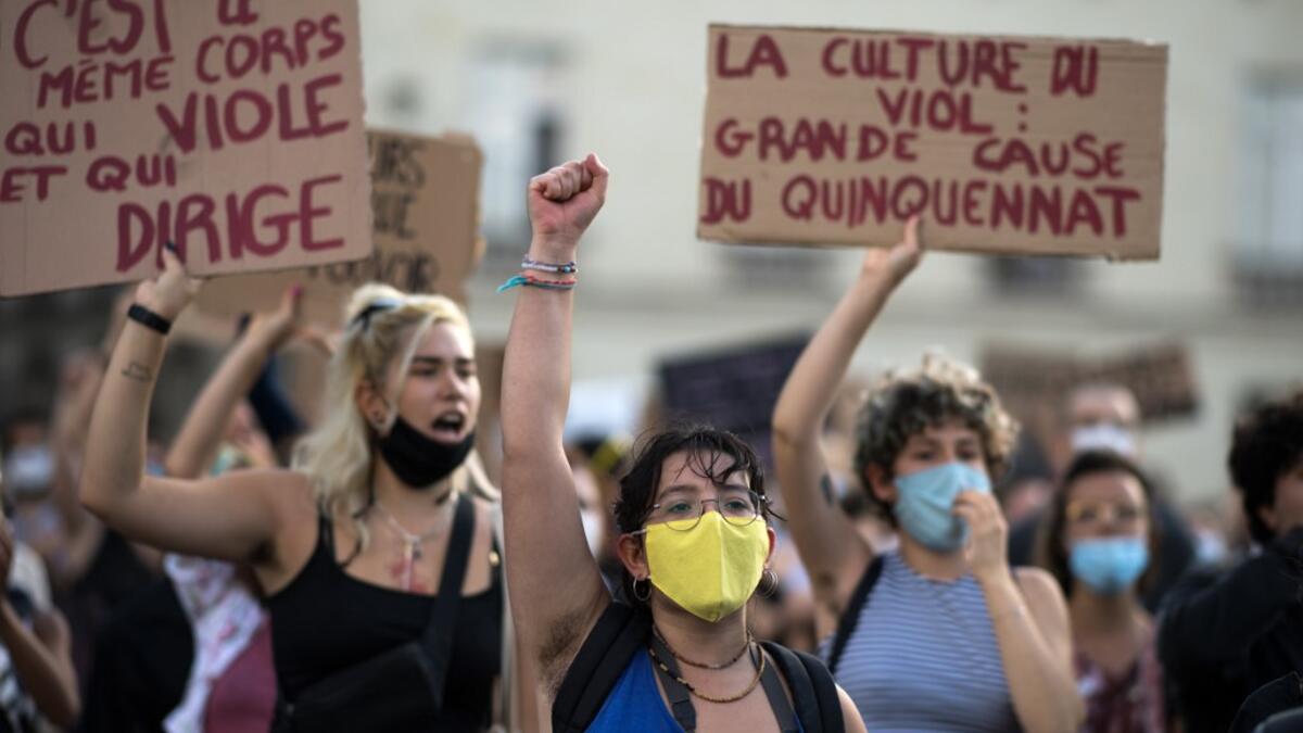 A protester holds their fist up during a demonstration called by feminist movements in Nantes, western France, on July 10, 2020, to denounce the nomination of French Interior Minister, facing rape accusations and French Justice Minister who criticised the #MeToo movement against sexual harassment. LOIC VENANCE / AFP