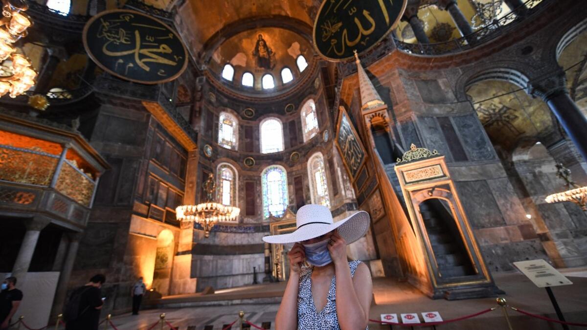 A tourist visits the inside of Hagia Sophia on July 10, 2020, in Istanbul, before a top Turkish court revoked the sixth-century Hagia Sophia's status as a museum, clearing the way for it to be turned back into a mosque. The Council of State, the country's highest administrative court which on July 2 debated a case brought by a Turkish NGO, cancelled a 1934 cabinet decision and ruled the UNESCO World Heritage site would be reopened to Muslim worshipping. The sixth-century Istanbul building -- a magnet for to
