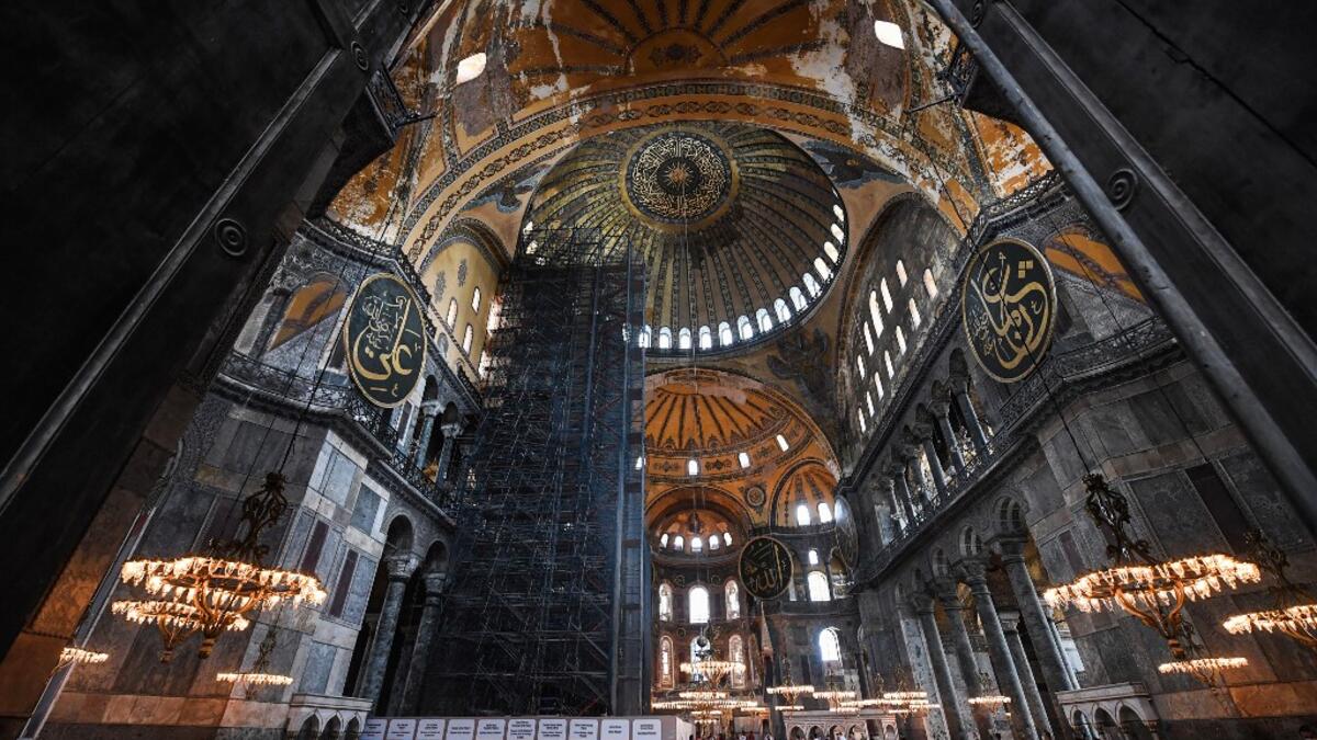 Tourists visit the inside of Hagia Sophia on July 10, 2020, in Istanbul, before a top Turkish court revoked the sixth-century Hagia Sophia's status as a museum, clearing the way for it to be turned back into a mosque. The Council of State, the country's highest administrative court which on July 2 debated a case brought by a Turkish NGO, cancelled a 1934 cabinet decision and ruled the UNESCO World Heritage site would be reopened to Muslim worshipping. The sixth-century Istanbul building -- a magnet for tour