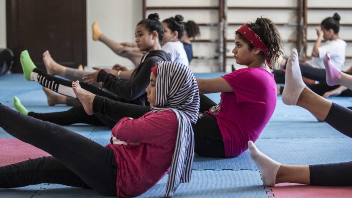 Youths from the "Children without Shelter" program attend a fitness sessions in their residences at Banati foundation in 6th October City on the outskirts of the capital Cairo on July 13, 2020. Khaled DESOUKI / AFP