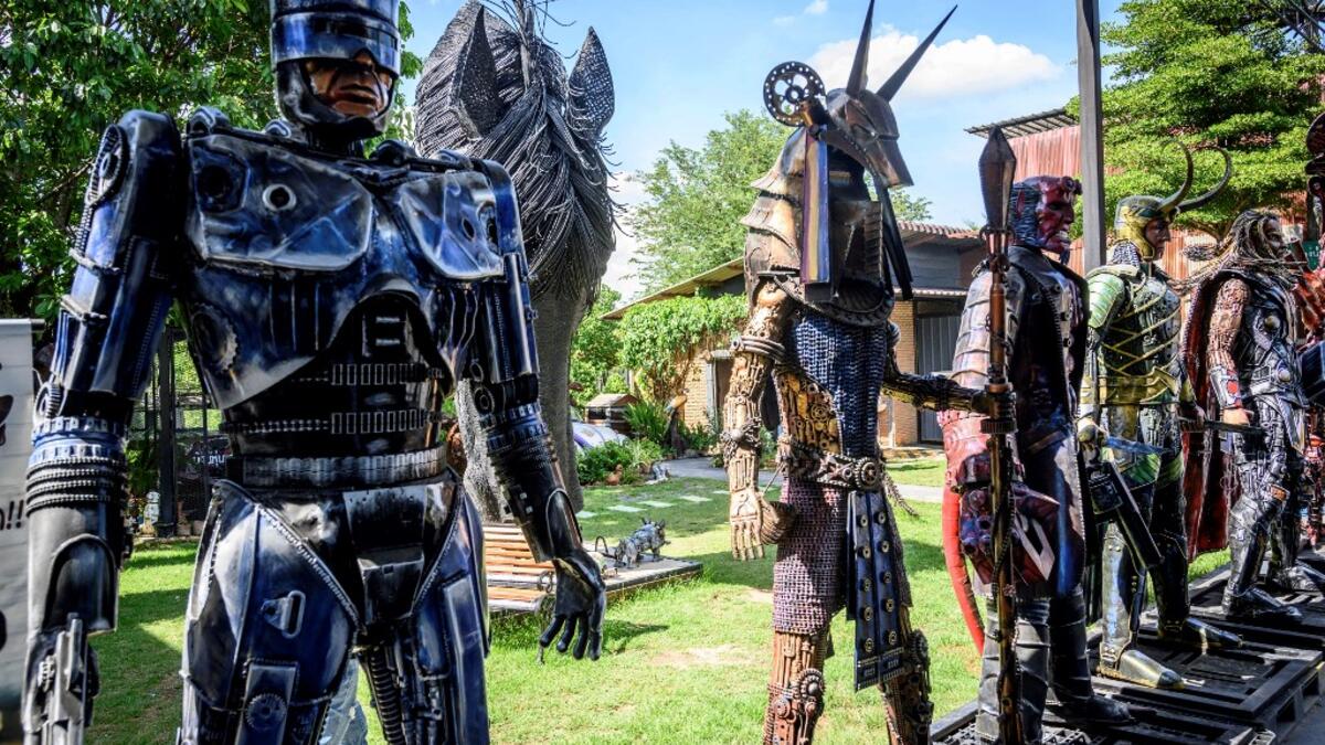 This photograph taken on July 18, 2020 shows a life-sized sculpture of Robocop and other figures made of scrap metal parts at the Ban Hun Lek museum in Ang Thong, some 100km north of Bangkok. "Ban Hun Lek" or "The House of Steel Robots" is a museum where a collective of artists display their scrap metal creations depicting popular comics and sci-fi film characters. Mladen ANTONOV / AFP