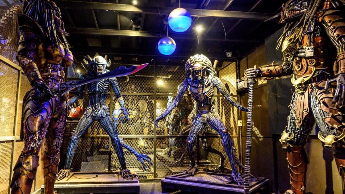 This photograph taken on July 18, 2020 shows life-sized sculptures of characters from the "Predator" film series made of scrap metal parts at the Ban Hun Lek museum in Ang Thong, some 100km north of Bangkok. "Ban Hun Lek" or "The House of Steel Robots" is a museum where a collective of artists display their scrap metal creations depicting popular comics and sci-fi film characters. Mladen ANTONOV / AFP