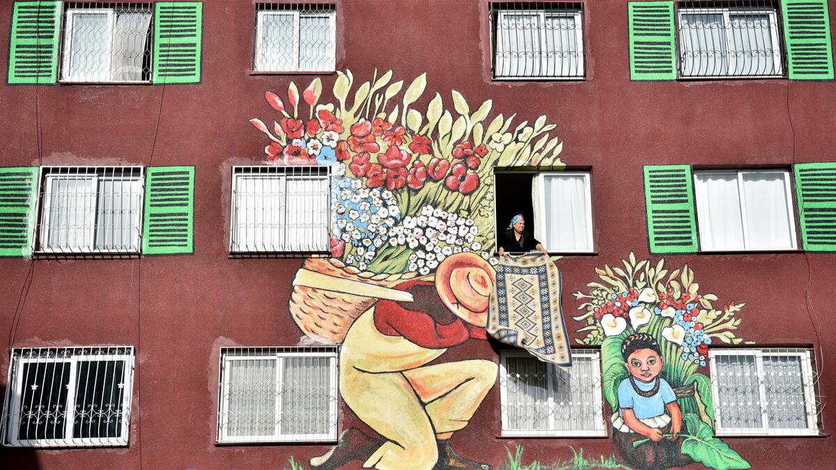 Within the scope of the project launched in Mersin, the walls of the old apartment buildings painted by Nazife Bilgin Hazar are decorated with the works of famous painters. (Twitter/@doganburak29)