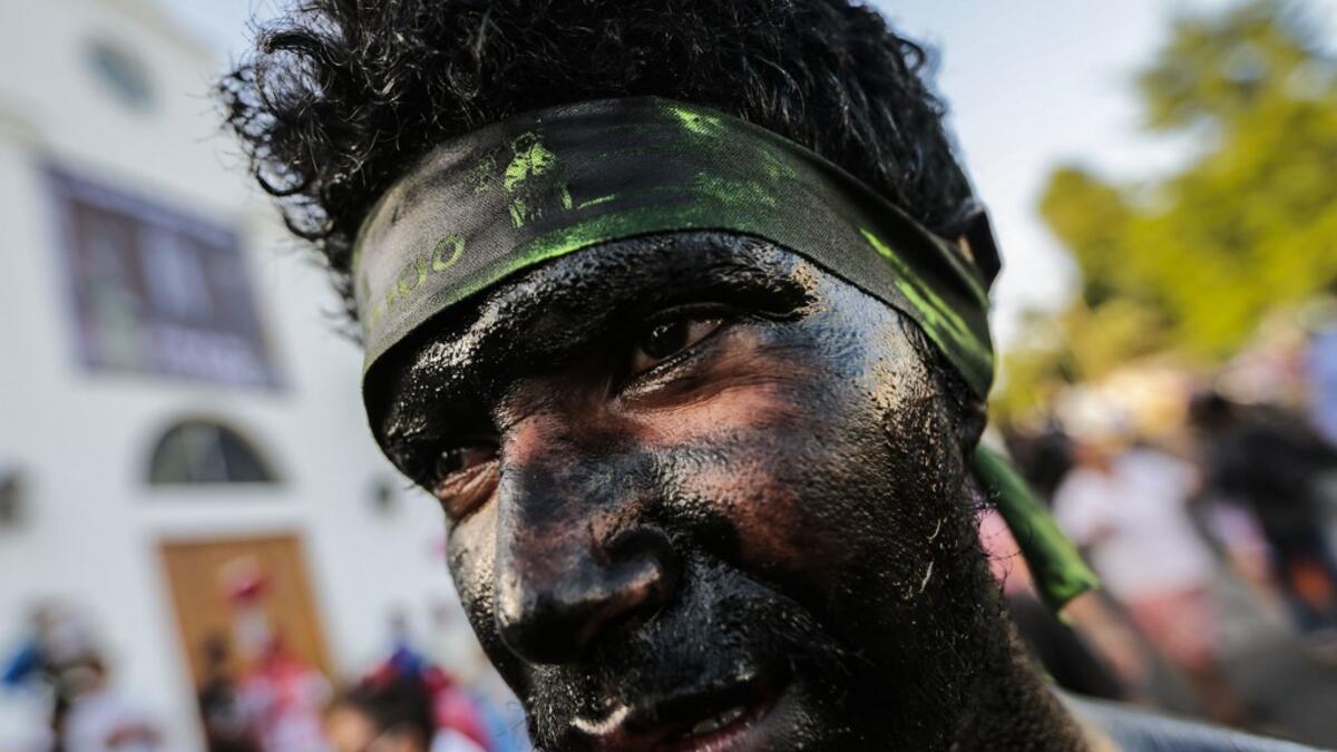 A Catholic faithful smeared in burnt oil takes part in the opening of the ten-day celebration of the Santo Domingo de Guzman festival, outside the Las Sierritas de Santo Domingo church in Managua, on August 1, 2020 amid the COVID-19 novel coronavirus pandemic. Despite the Catholic Church cancelling all religious activities due to the coronavirus pandemic, devotees gathered outside the church for the celebration. Inti OCON / AFP