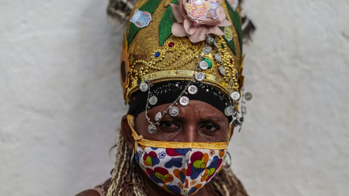 A Catholic faithful poses for a picture as she takes part in the opening of the ten-day celebration of the Santo Domingo de Guzman festival, outside the Las Sierritas de Santo Domingo church in Managua, on August 1, 2020 amid the COVID-19 novel coronavirus pandemic. Despite the Catholic Church cancelling all religious activities due to the coronavirus pandemic, devotees gathered outside the church for the celebration. Inti OCON / AFP