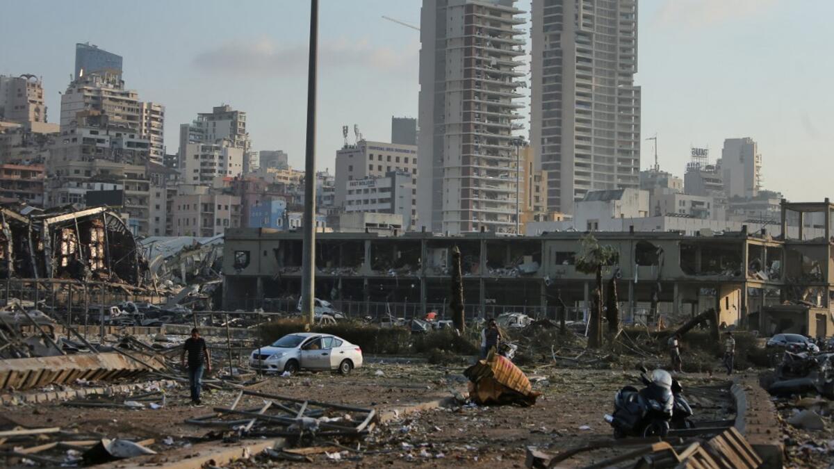 A picture shows the scene of an explosion at the port in the Lebanese capital Beirut on August 4, 2020. Two huge explosion rocked the Lebanese capital Beirut, wounding dozens of people, shaking buildings and sending huge plumes of smoke billowing into the sky. STR / AFP