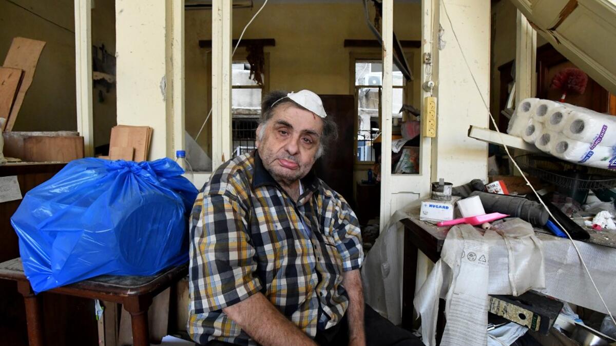 A man sits inside his damaged house in the Lebanese capital Beirut on August 6, 2020, two days after a massive explosion shook the Lebanese capital. The blast, which appeared to have been caused by a fire igniting 2,750 tonnes of ammonium nitrate left unsecured in a warehouse, was felt as far away as Cyprus, some 150 miles (240 kilometres) to the northwest. The scale of the destruction was such that the Lebanese capital resembled the scene of an earthquake, with thousands of people left homeless and thousan