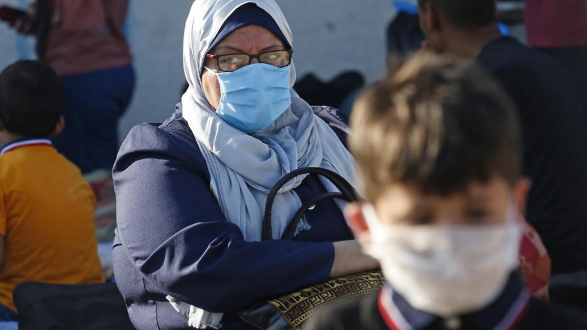 Palestinians wait to cross to the Egyptian side of Rafah border crossing after months of closure due to the coronavirus pandemic in the southern Gaza Strip, on August 11, 2020. SAID KHATIB / AFP