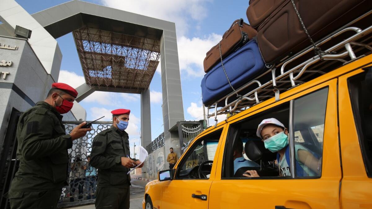 Palestinians prepare to leave Rafah border crossing with Egypt after months of closure due to the coronavirus pandemic in the southern Gaza Strip, on August 11, 2020 . SAID KHATIB / AFP