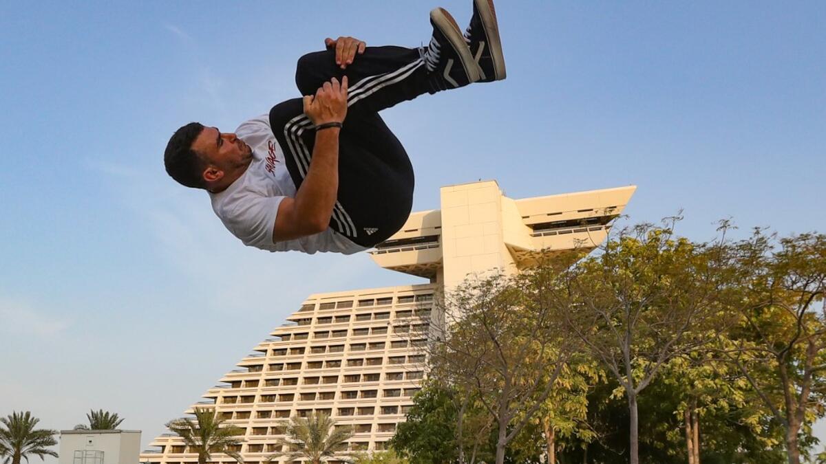 Achref Bejaoui, 25, performs parkour, a sport that originated in France in the 1990s, which involves getting around urban obstacles with a fast-paced mix of jumping, vaulting, running and rolling, in the Qatari capital Doha, on August 11, 2020. Parkour, also known as free-running, has now found a small but committed following in Qatar despite evening temperatures that hover around 40 degrees Celsius (104 Fahrenheit) in summer and over-zealous security guards unfamiliar with the sport. KARIM JAAFAR / AFP