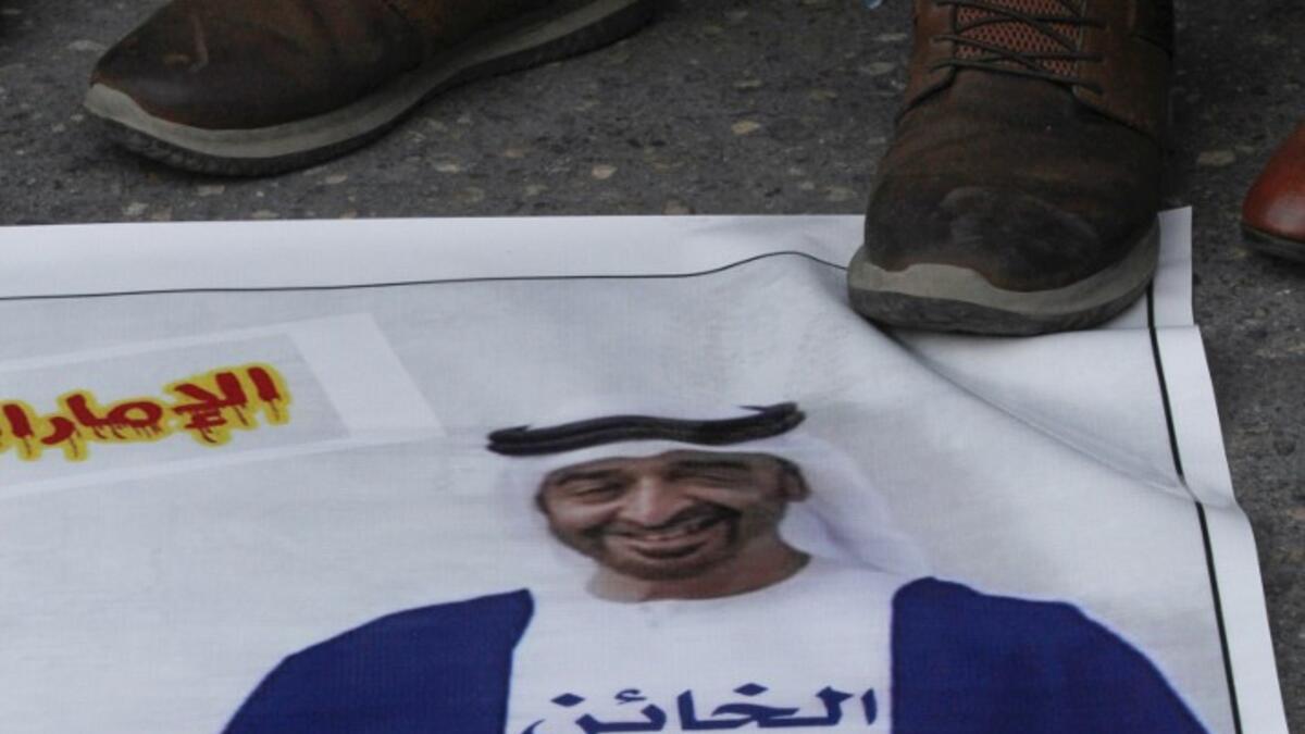 Palestinian refugees tread on a picture of Abu Dhabi Crown Prince Sheikh Mohammed bin Zayed Al Nahyan, during a demonstration against the Emirati-Israeli agreement in the Lebanese southern coastal city of Tyre, on August 15, 2020. Mahmoud ZAYYAT / AFP