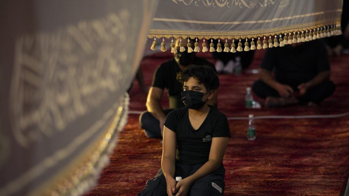 Iraqis respect social distancing at a mosque on August 20, 2020, as Muslim Shiites start marking Ashura under new health guidelines to limit the risk of exposure to Covid-19 virus. Hussein FALEH / AFP