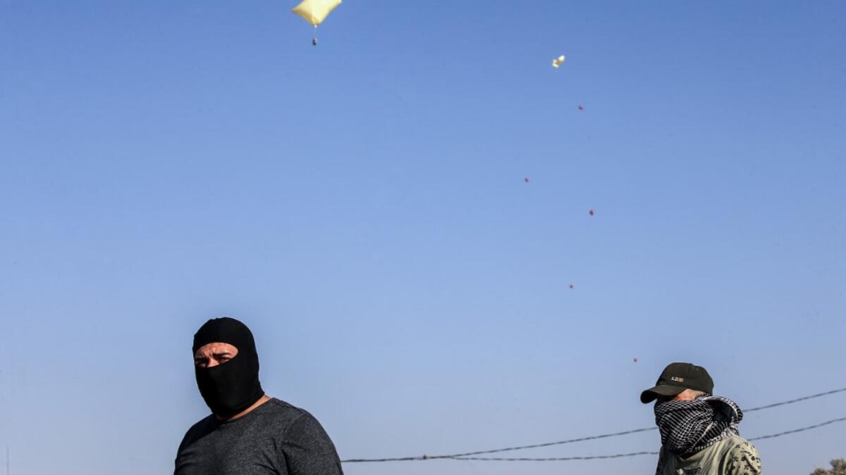 Inflated plastic bags carrying incendiary devices float in the air upon being released by Palestinians and flown towards Israel, near Rafah along the border between the Gaza Strip and Israel on August 21, 2020. SAID KHATIB / AFP