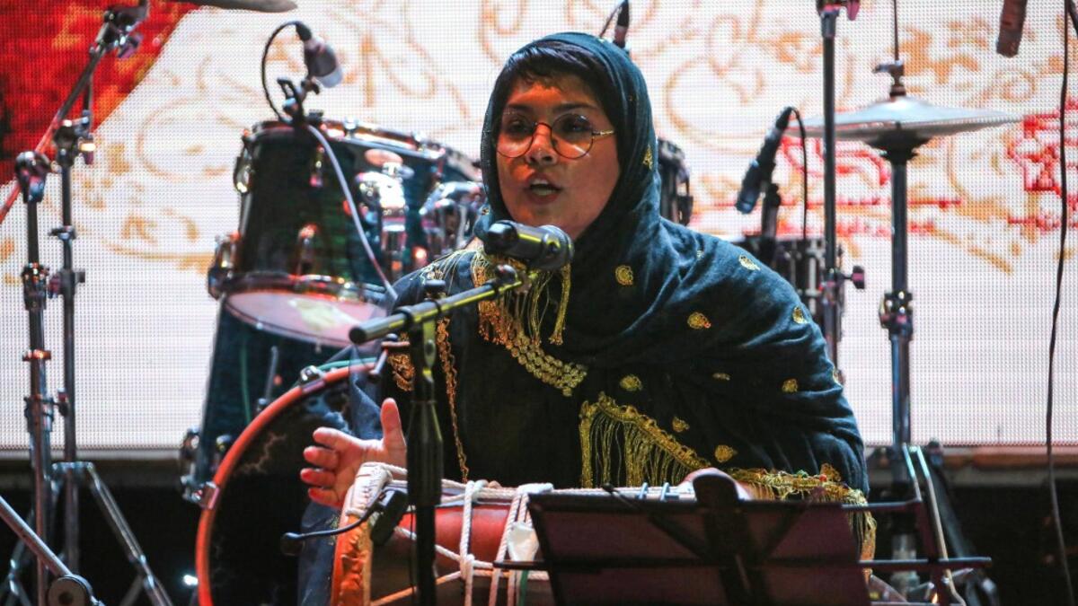 Faezeh Mohseni, drummer of the Iranian all-women music band "Dingo" performs with other band members at a concert during the state-organised "Persian Gulf music" festival at Avini Hall in Iran's southern Gulf port city of Bandar Abbas on April 29, 2019. ATTA KENARE / AFP
