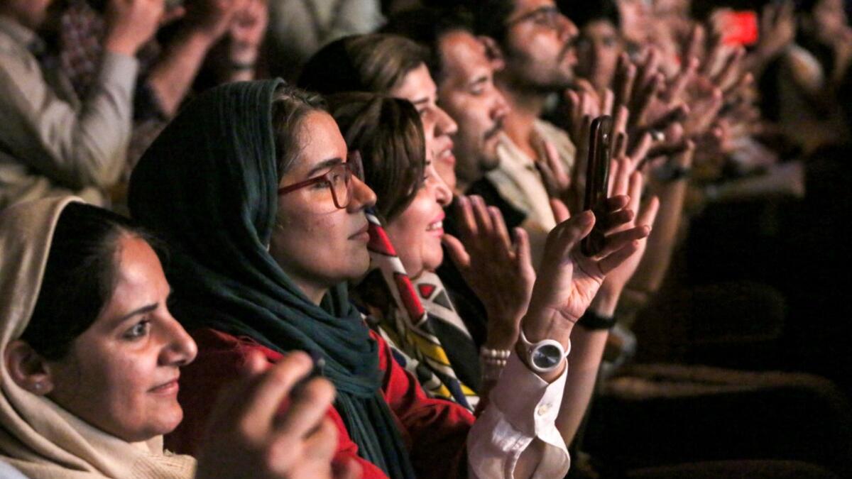 Women audience members applaud as they attend a performance by the Iranian all-women music band "Dingo" during the state-organised "Persian Gulf music" festival at Avini Hall in Iran's southern Gulf port city of Bandar Abbas on April 29, 2019.ATTA KENARE / AFP
