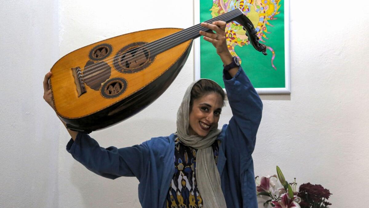 Noushin Yousefzadeh, a member of the all-women Iranian music band "Dingo" who plays the Oud (Middle Eastern lute), poses for a picture as she practises at a home studio called the "Dingo room" in Iran's southern Gulf port city of Bandar Abbas on April 30, 2019. ATTA KENARE / AFP