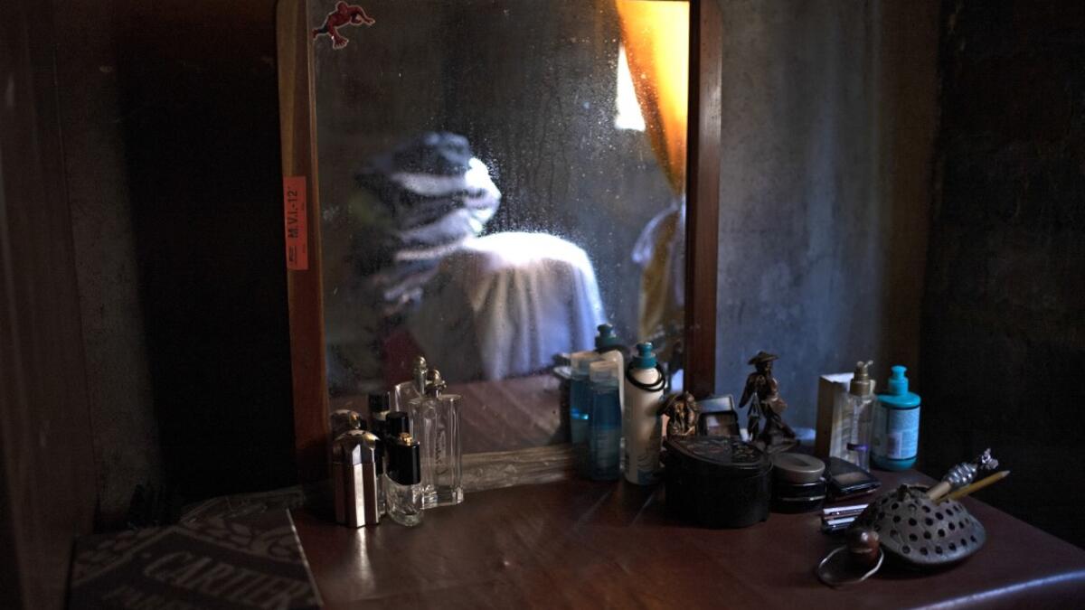 View of belongings at the bedroom of late photojournalist Franklin Rivera, 52, who died from COVID-19, in Ciudad Delgado, El Salvador, on July 13, 2020. Global deaths from the coronavirus have almost reached on September 25, 2020 the grim threshold of one million. Around one-third of fatalities were in Latin America, where countries with overstretched medical resources are preparing for a further onslaught. Yuri CORTEZ / AFP