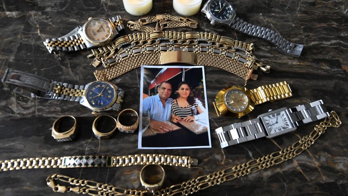 Picture of a photo and jewellery which belonged to Honduran journalist David Romero, head of Globo radio and TV station, who died of complications from the novel coronavirus COVID-19 on July 18, taken at his house in Tegucigalpa, on July 22, 2020. Global deaths from the coronavirus have almost reached on September 25, 2020 the grim threshold of one million. Around one-third of fatalities were in Latin America, where countries with overstretched medical resources are preparing for a further onslaught. Orland