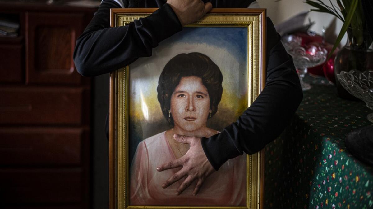 Peruvian Liset Diaz, 35, holds a painting of her grandmother Edita Leiva -in her youth-, 76, who died from COVID-19 at her home in Chorrillos, south of Lima, Peru on August 11, 2020. Global deaths from the coronavirus have almost reached on September 25, 2020 the grim threshold of one million. Around one-third of fatalities were in Latin America, where countries with overstretched medical resources are preparing for a further onslaught. ERNESTO BENAVIDES / AFP