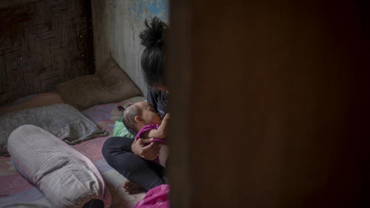 This picture taken on February 9, 2019 shows Nurlina, 19, who got married in 2017, breastfeeding her daughter in the village of Galung Lombok in West Sulawesi. Child marriage has long been common in traditional communities from the Indonesian archipelago to India, Pakistan and Vietnam, but numbers had been decreasing as charities made inroads by encouraging access to education and women's health services. YUSUF WAHIL / AFP