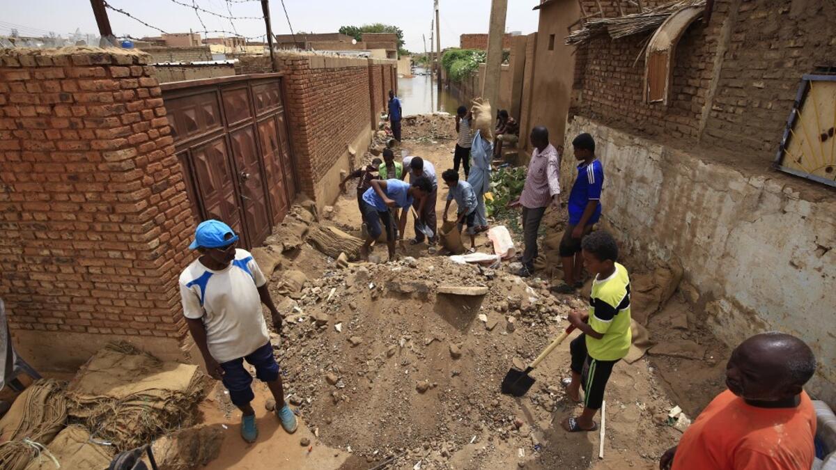 On Tuti Island, the highest Nile waters since records began a century ago have left people struggling to build dams by filling bags with sand and small stones to stem the flood. ASHRAF SHAZLY / AFP