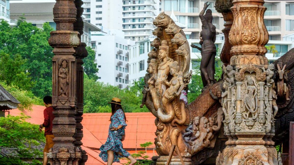 This photograph taken on September 2, 2020 shows tourists visiting the all wooden Sanctuary of Truth Hindu-Buddhist temple and museum in Pattaya. Mladen ANTONOV / AFP
